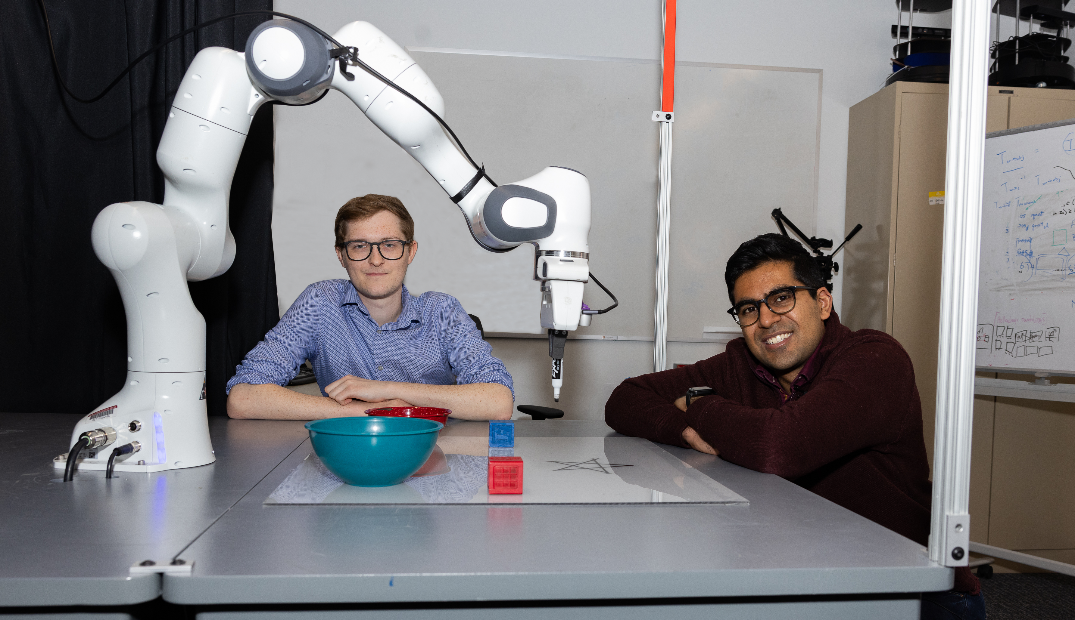 To help robots execute open-ended tasks safely, MIT researchers used vision models to see what’s near the machine and model its constraints. Their “PRoC3S” strategy has an LLM sketch up an action plan that’s checked in a simulator to ensure it’ll work in the real world (Credit: Mike Grimmett/MIT CSAIL).