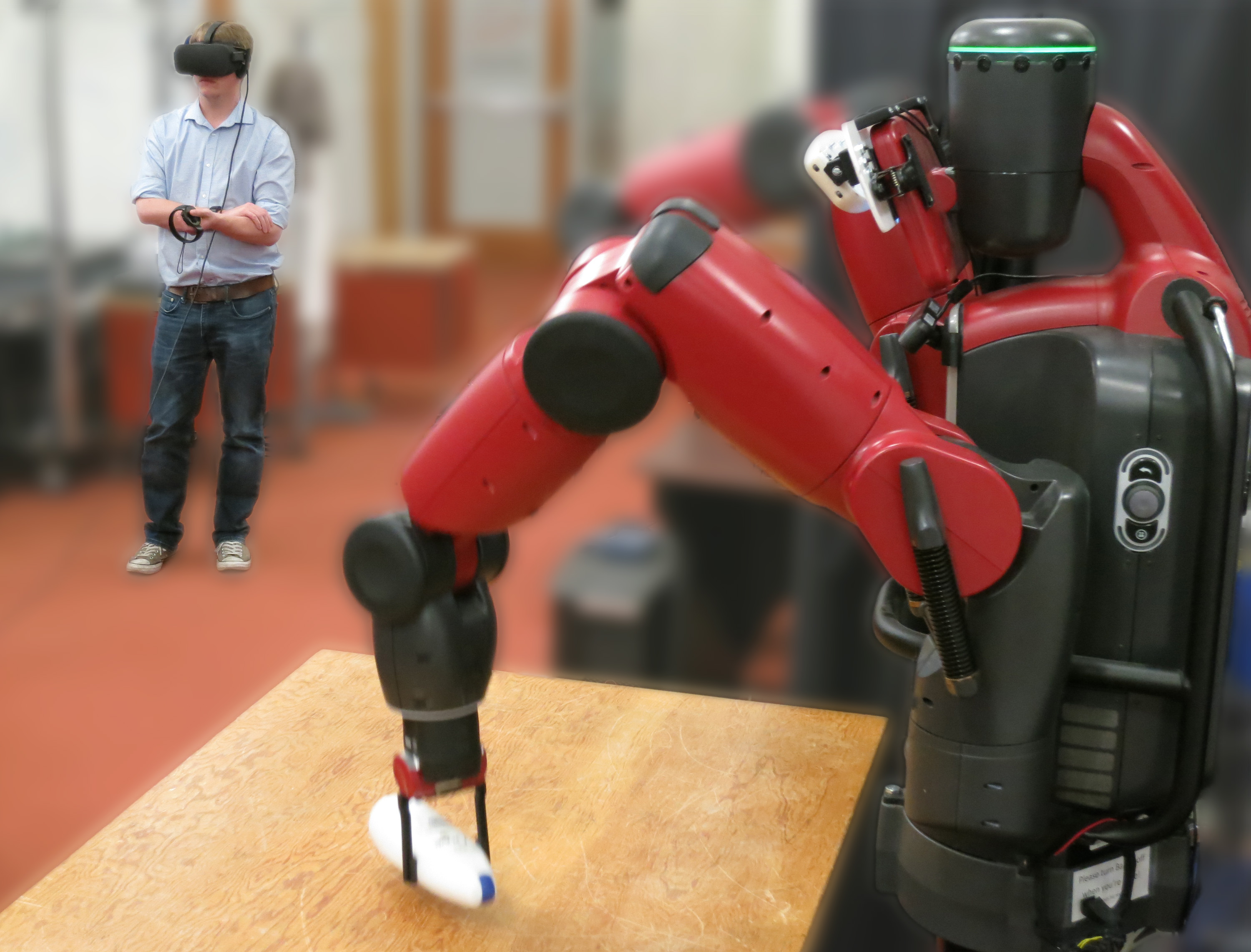 A person uses virtual reality to supervise an autonomously learning robot, and remotely controls it to provide demonstrations when needed.